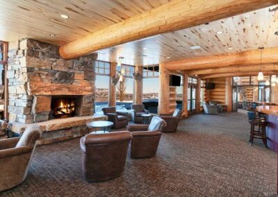 Log Home Entertainment Room With Stone Fireplace