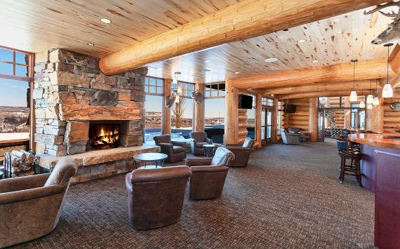 Log Home Entertainment Room With Stone Fireplace